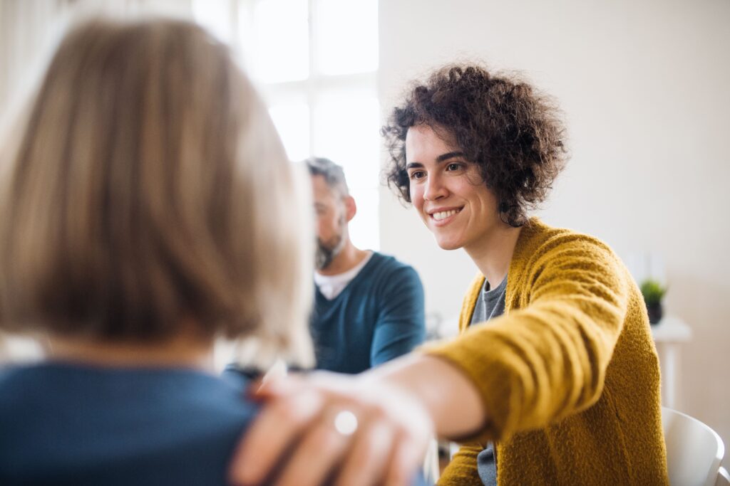 A woman shares her experiencs during group therapy